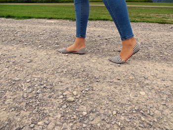 Low section of woman standing on ground
