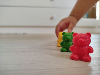 Close-up of hand holding toy on table