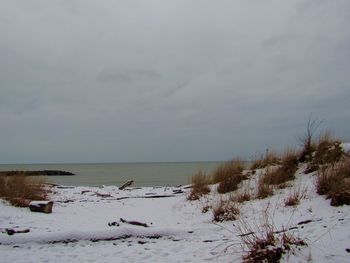 Scenic view of snow covered land against sky