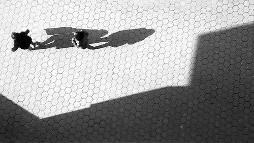 Shadow of man on tiled floor