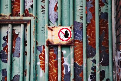 Close-up of rusty sign on wall