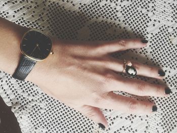 Cropped image of woman wearing wristwatch and ring