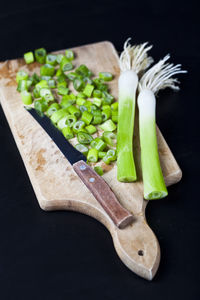 High angle view of chopped vegetables on table against black background