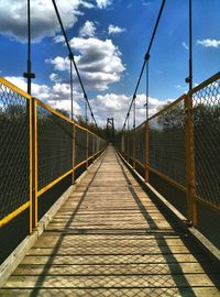 Footbridge over bridge against sky