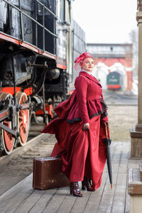 Portrait of young woman standing in city