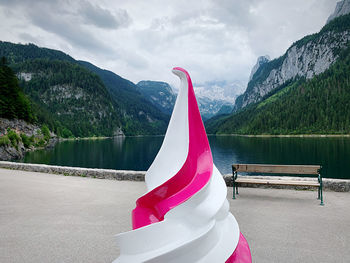 Scenic view of lake by mountains against sky