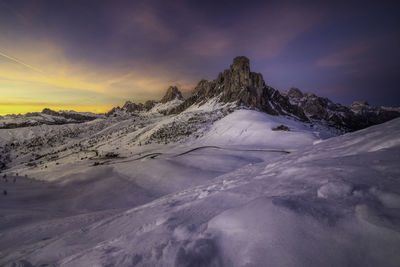 Scenic view of snowcapped mountains against sky during sunset