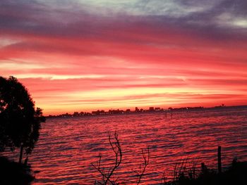 Scenic view of lake against orange sky