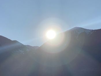 Scenic view of mountains against sky on sunny day