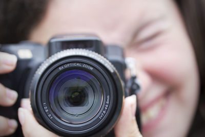 Cropped image of man holding camera