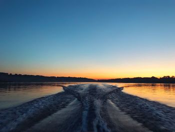 Scenic view of sea against clear sky during sunset