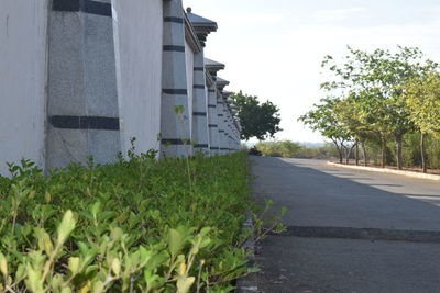 Road by building against sky