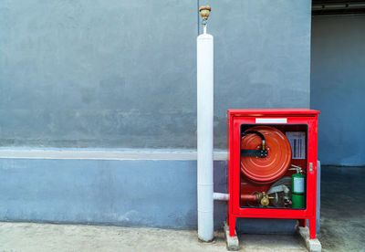 Red fire hydrant on wall