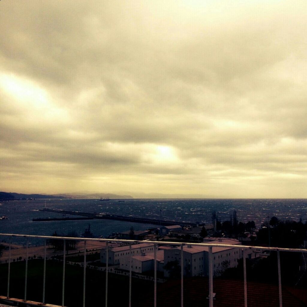 sky, cloud - sky, architecture, built structure, sunset, cloudy, building exterior, city, cityscape, cloud, overcast, dramatic sky, weather, orange color, sea, storm cloud, railing, nature, scenics, dusk