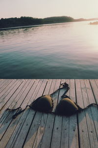 Bra on pier over lake during sunset