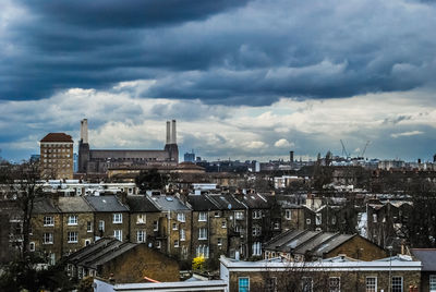 View of cityscape against cloudy sky