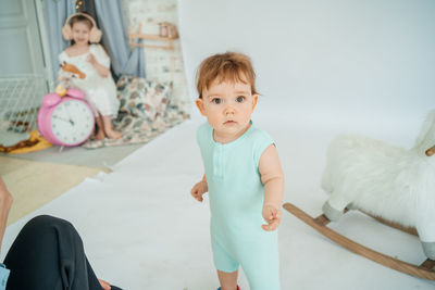 Little boy on white background girl with pink alarm clock. high quality photo