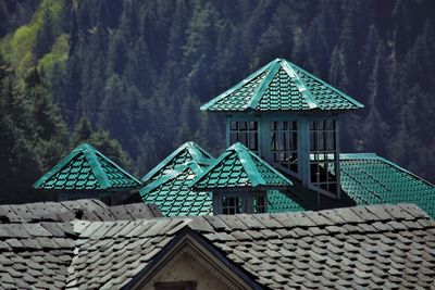 High angle view of house roof and building against mountains