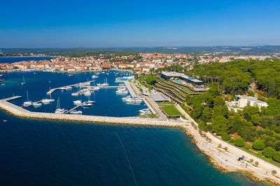 High angle view of city by sea against blue sky in the town of rovinj