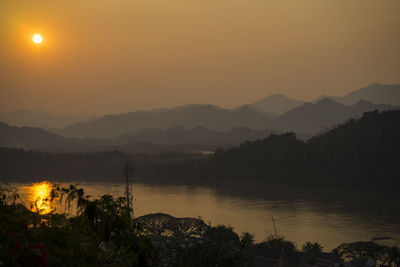 Scenic view of lake against sky during sunset