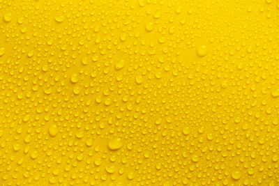 Full frame shot of wet yellow glass
