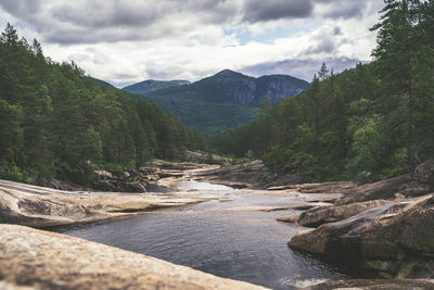 Scenic view of river amidst mountains against sky