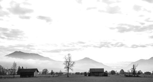 Built structures on field against sky