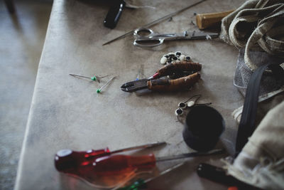 High angle view of various tools on table at workshop