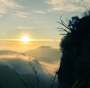 Scenic view of silhouette mountains against sky during sunset