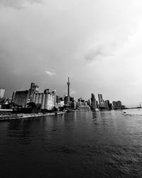 Buildings in city against cloudy sky