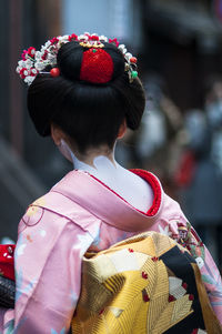 Rear view of girl wearing kimono outdoors