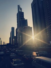 Modern buildings in city against sky during sunset