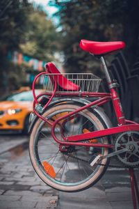 Red bicycle parked on street