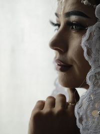 Close-up of bride against white background