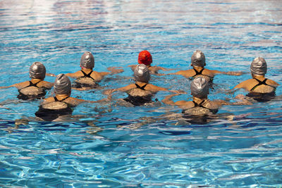 Rear view of swimmers in pool