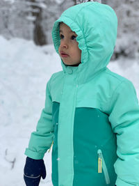 Portrait of boy standing on snow