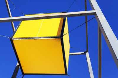 Low angle view of metallic structure against clear blue sky