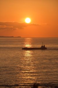 Scenic view of sea against orange sky