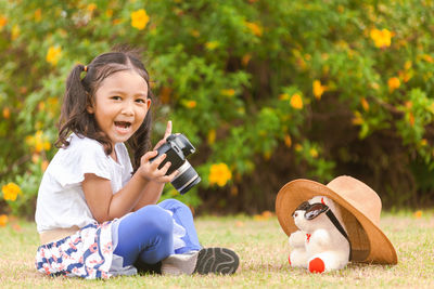 Portrait of a smiling girl sitting outdoors