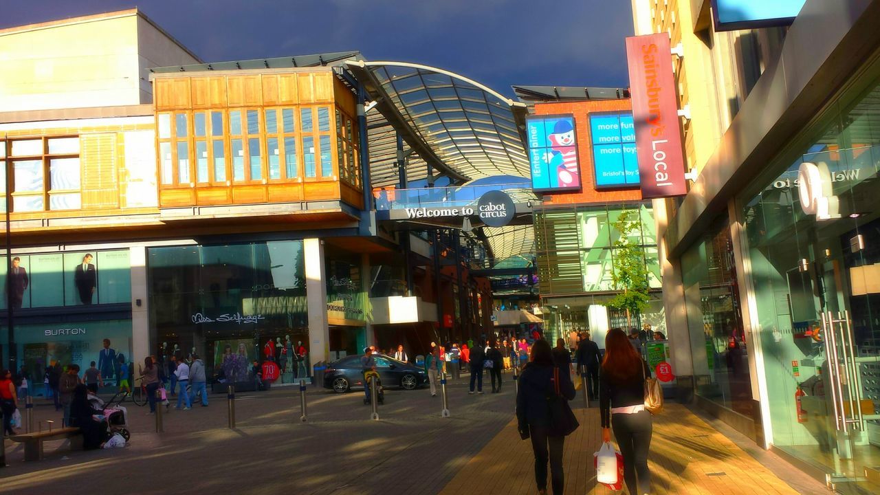 architecture, building exterior, built structure, city, men, street, city life, walking, person, building, large group of people, lifestyles, sky, city street, outdoors, road, incidental people, residential building, transportation