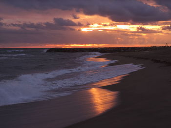 Scenic view of beach against sky during sunset