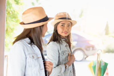 Portrait of young woman wearing hat