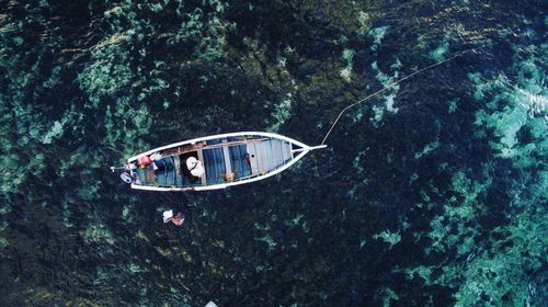 High angle view of fisherman sitting in boat