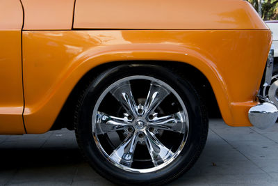 Detail of the wheel of an old car in a light orange color. salvador bahia brazil.