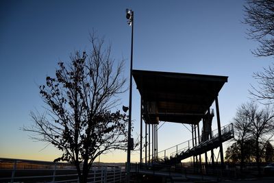 Low angle view of bridge against sky during sunset