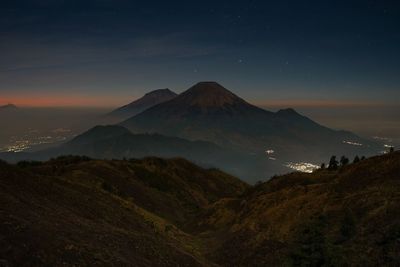 Scenic view of mountains against sky at night