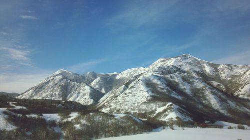 Scenic view of snowcapped mountains against sky