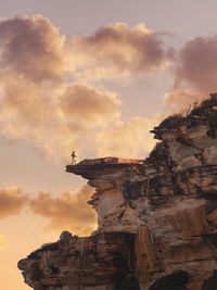 Low angle view of rock formation against sky during sunset