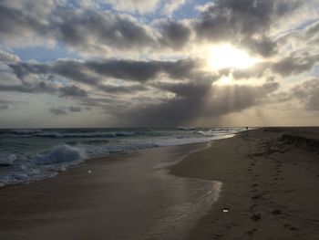 Scenic view of beach against sky during sunset