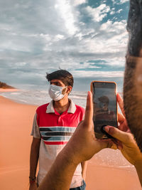 Covid 19 pose, photograph of man wearing mask 